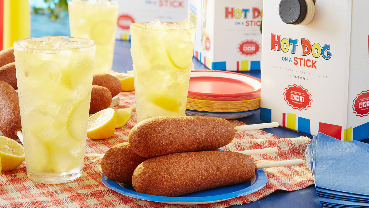 Hot Dog on a Stick on a plate with lemonade