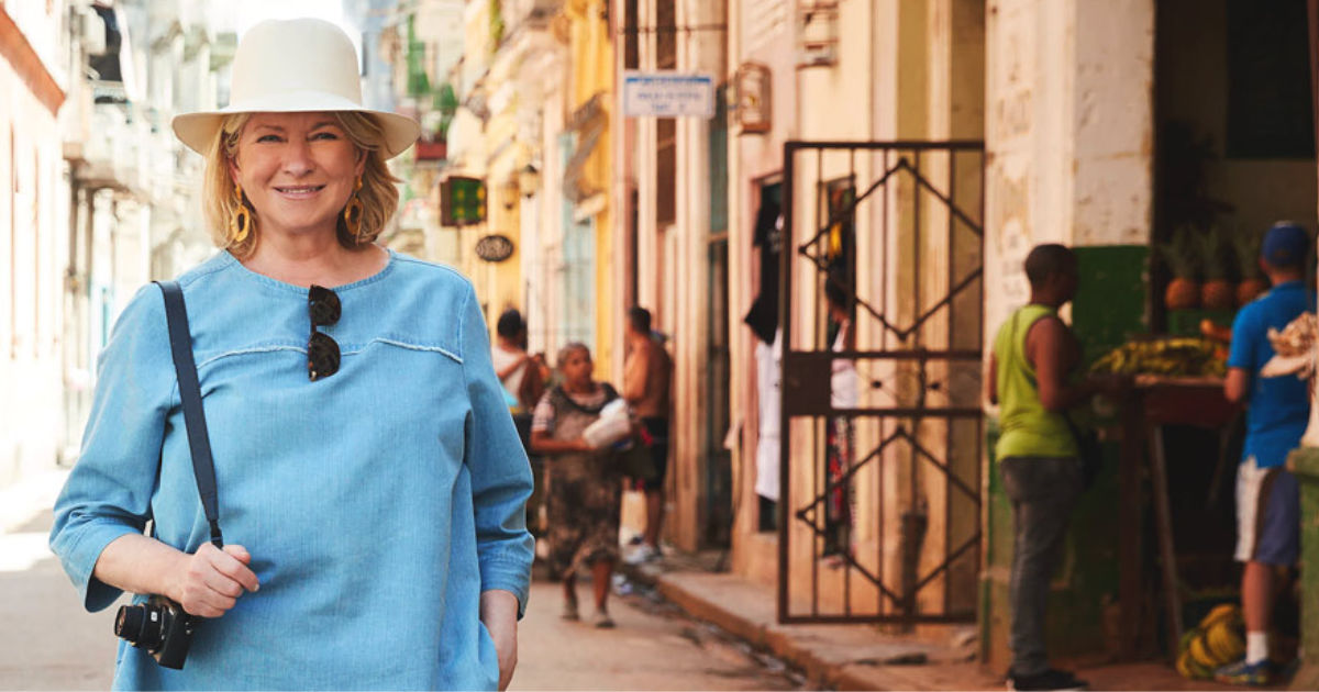 Martha Stewart in a hat standing with her camera