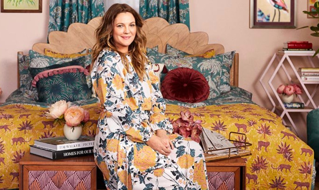 woman sitting on bed with colorful bedding