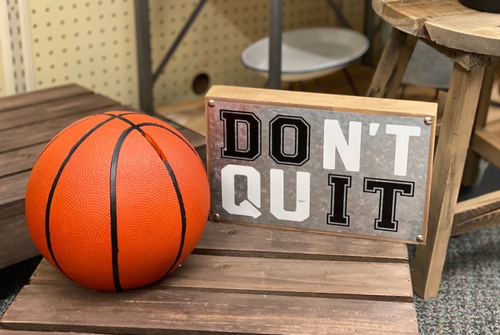basketball and don't quit sign on wooden table in store - kids decor themes hobby lobby