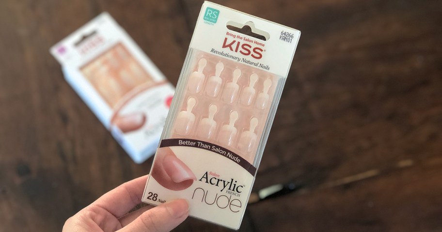 hand holding a pack of kiss press-on nails