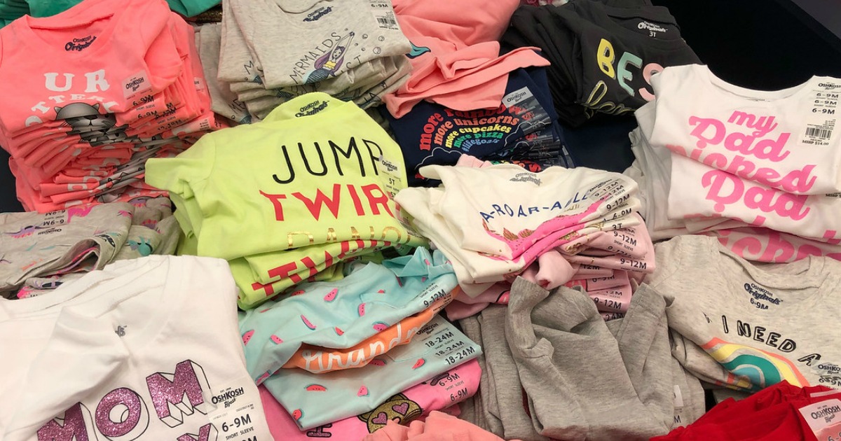 several oshkosh b'gosh girls graphic tees on table display at store