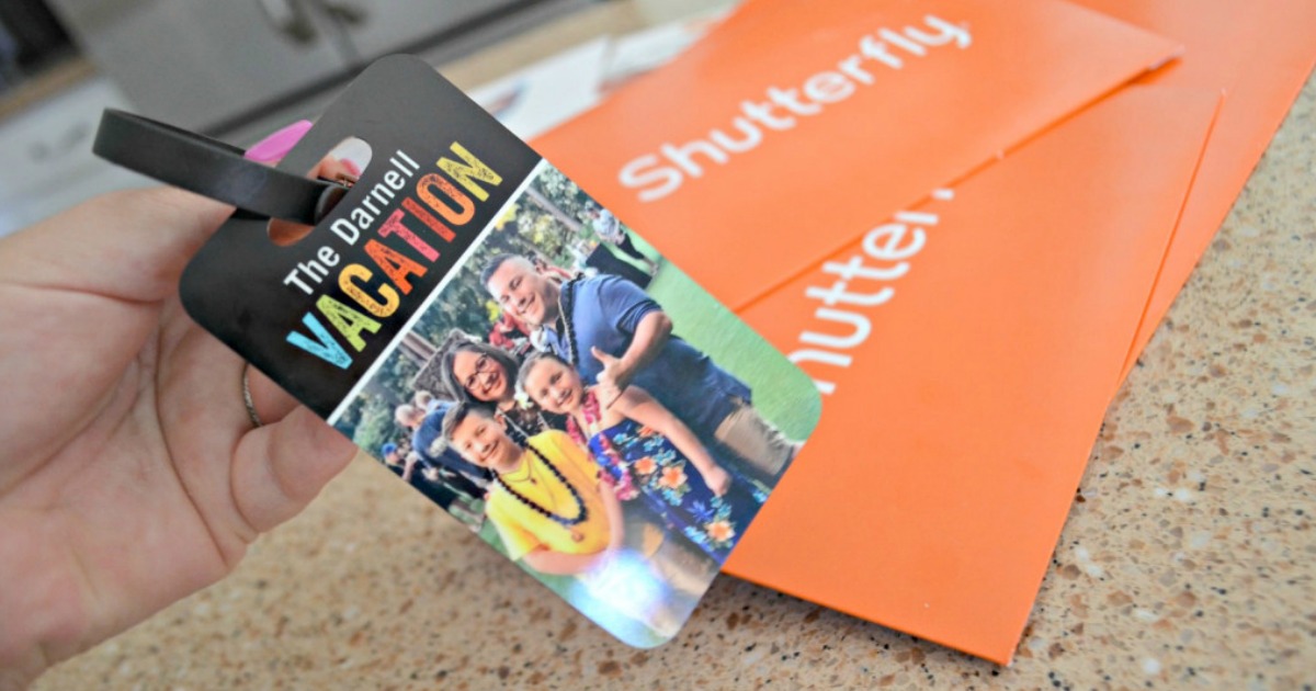 Custom Shutterfly luggage tag next to shutterfly orange envelope