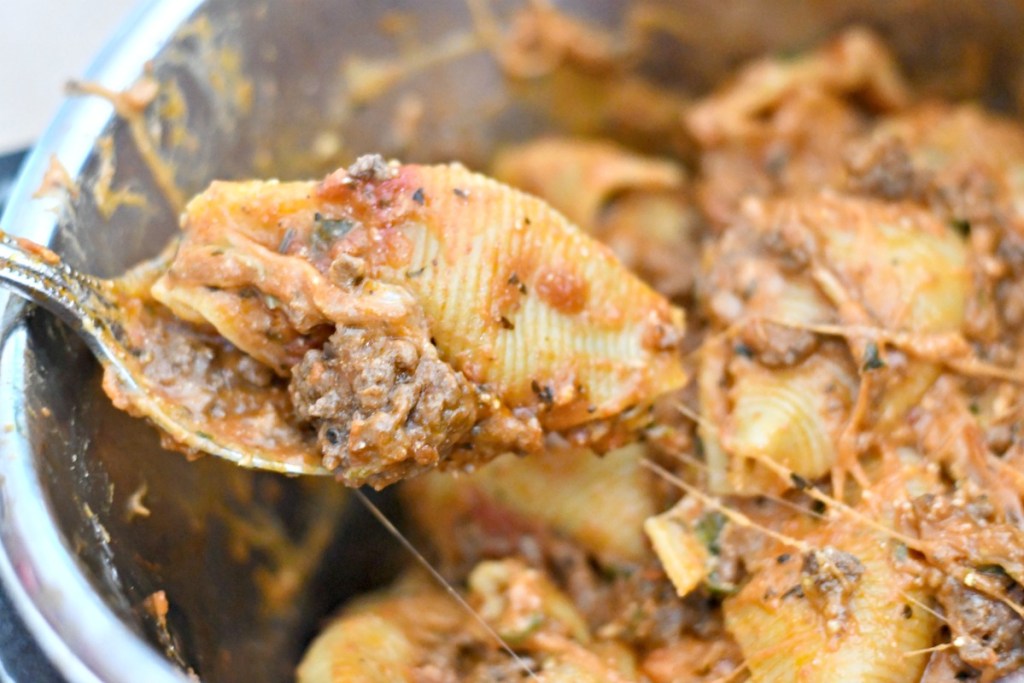 cheesy meaty stuffed shells on a spoon in an instant pot 