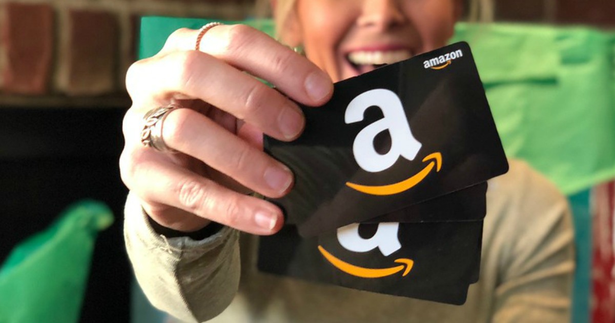 woman holding up amazon gift cards for Amazon cash 