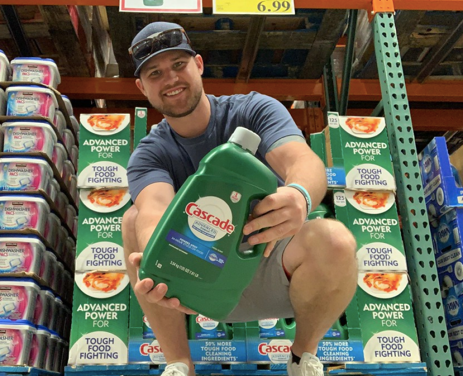 Man holding Cascade Liquid Dishwasher Detergent Bottle at Costco