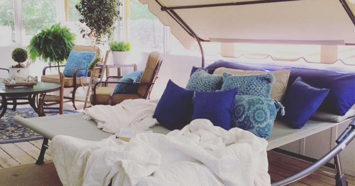 giant outdoor lounger bed with pillows on it