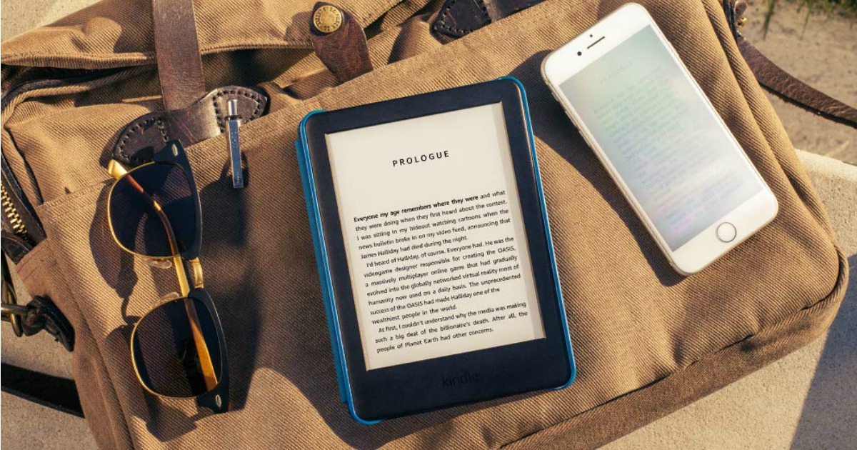 kindles sitting on towel with sunglasses