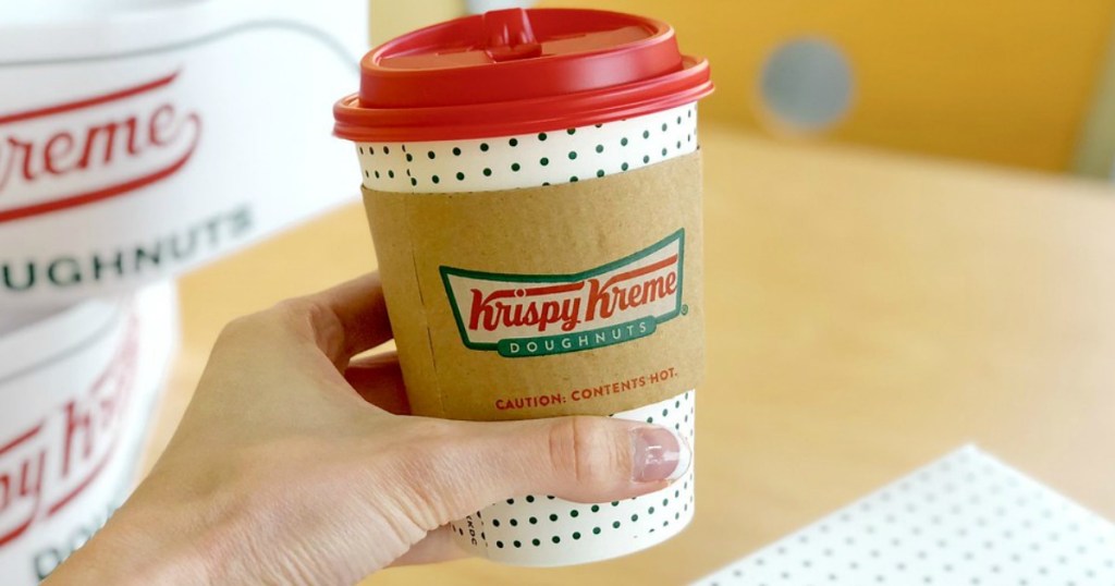 hand holding white and red Krispy Kreme coffee