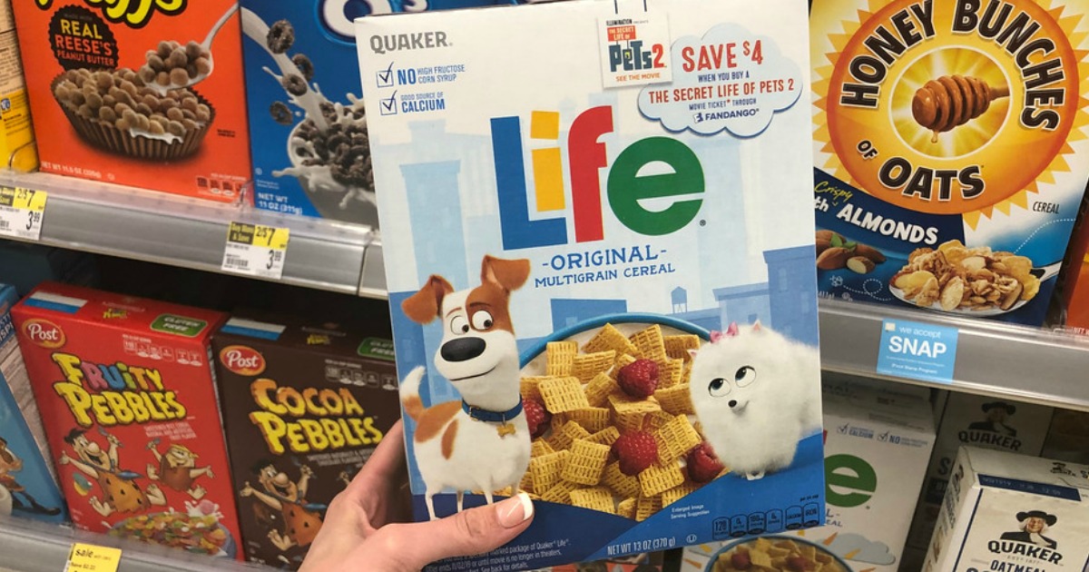 hand holding box of life cereal near store display