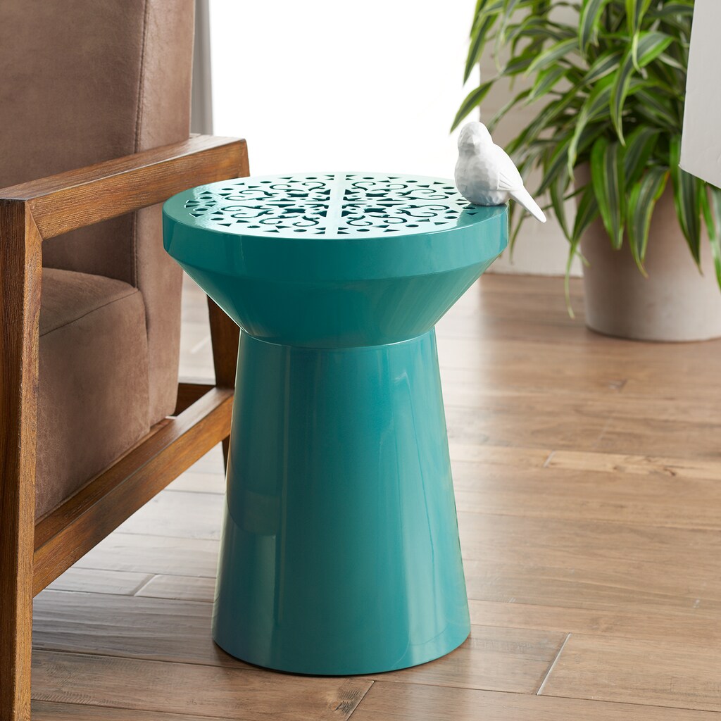 teal table with white ceramic bird on it