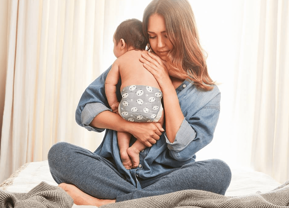 The Honest Company Panda Diapers on a baby hugged by mom