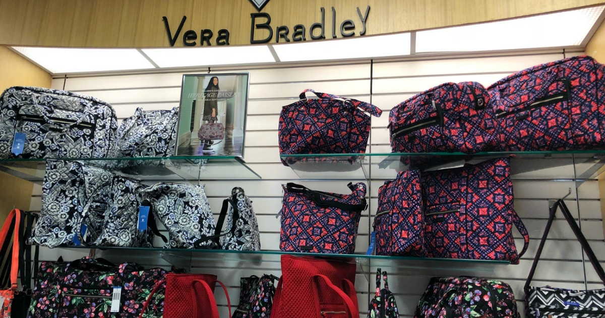 Vera Bradley assorted bags, on glass shelving in store