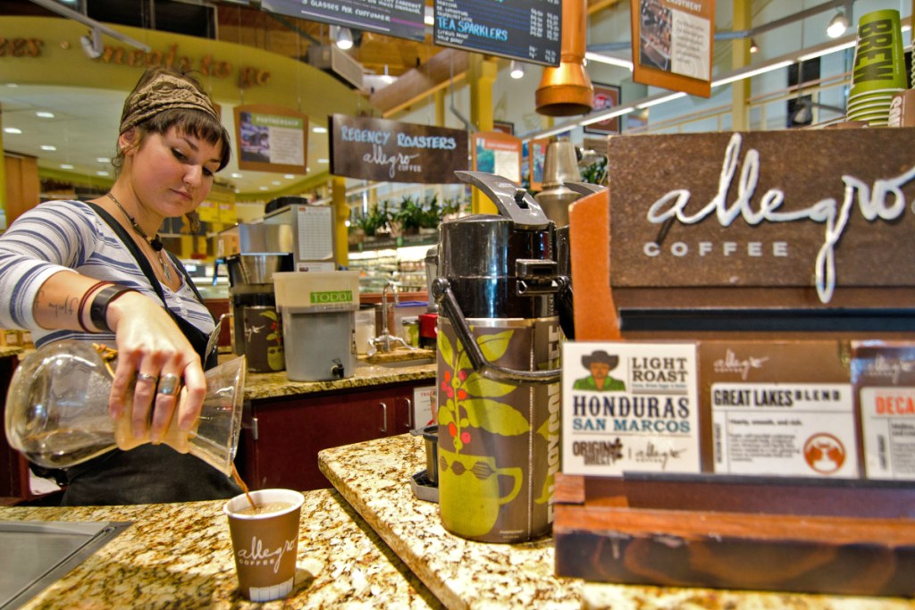 woman pouring Allegro coffee at Whole Foods Market