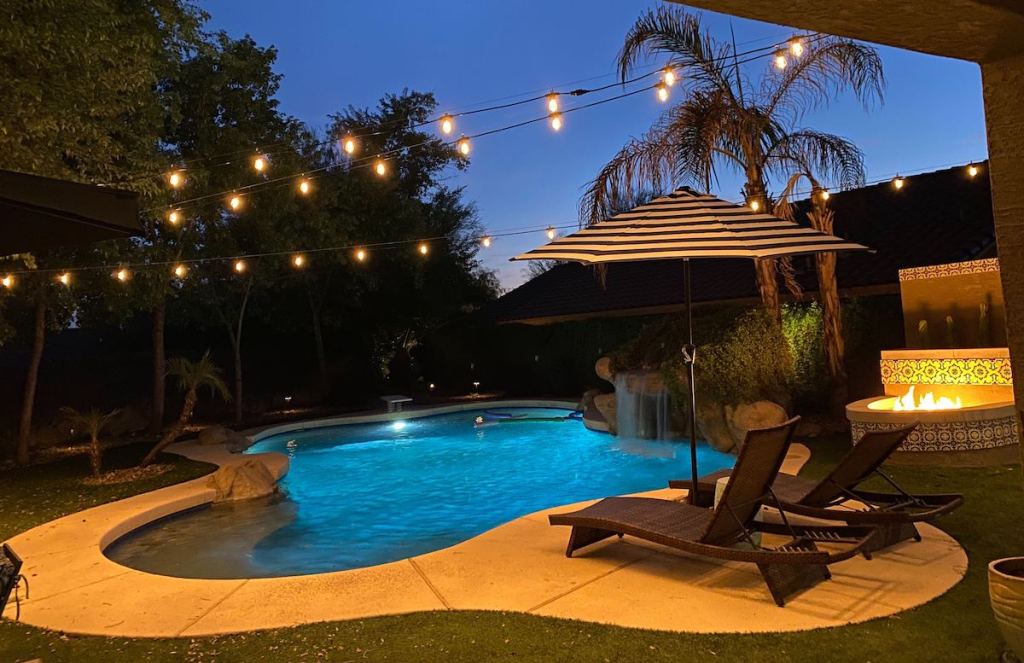 backyard with pool fire pit and string lights - selling your home