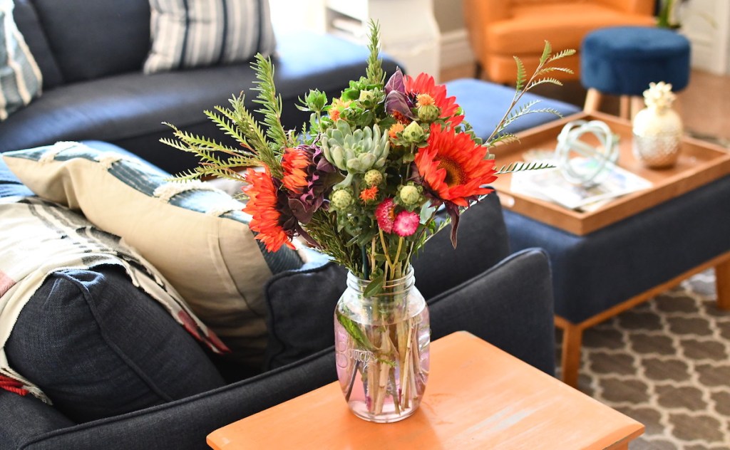 bouquet of flowers sitting on end table in living room - selling your home