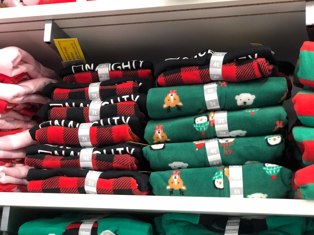 stacks of christmas pajamas on store shelf