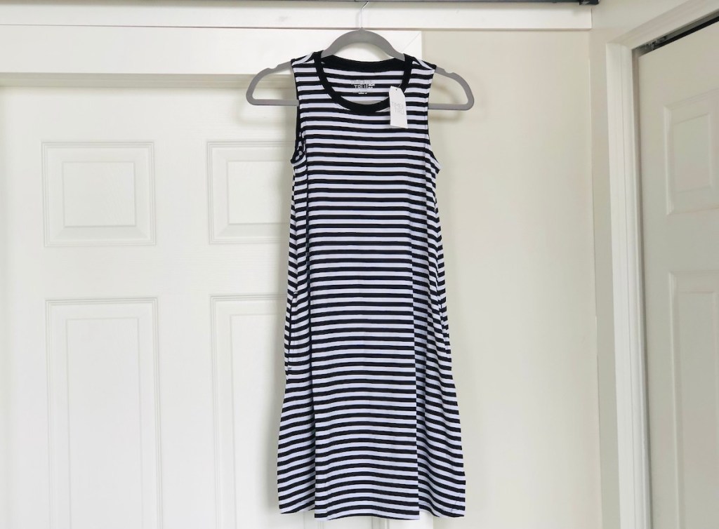 black and white striped dress hanging above door