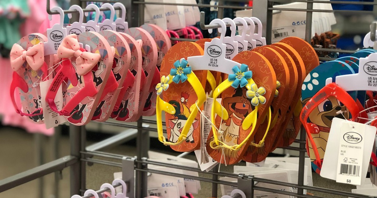 several pairs of kids flip flops hanging on store display