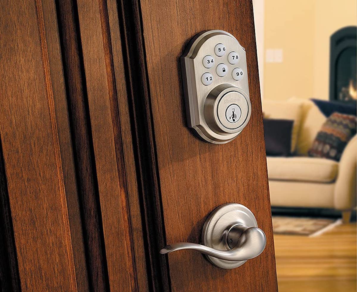 wood door with silver door knob and keyless door lock key pad