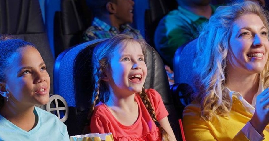 girls and woman sitting in movie theater seats for what to buy in august to stay cool