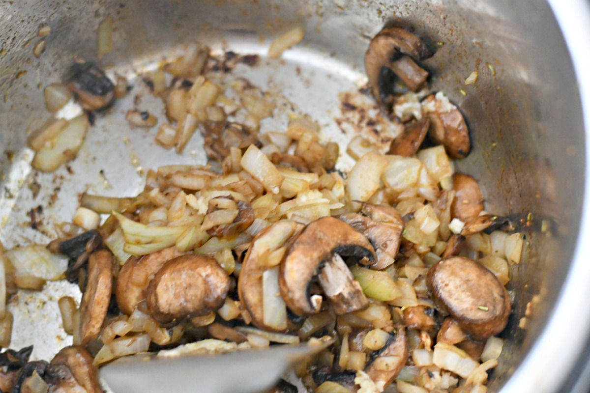 sauteed mushrooms and onions at the bottom of the instant pot