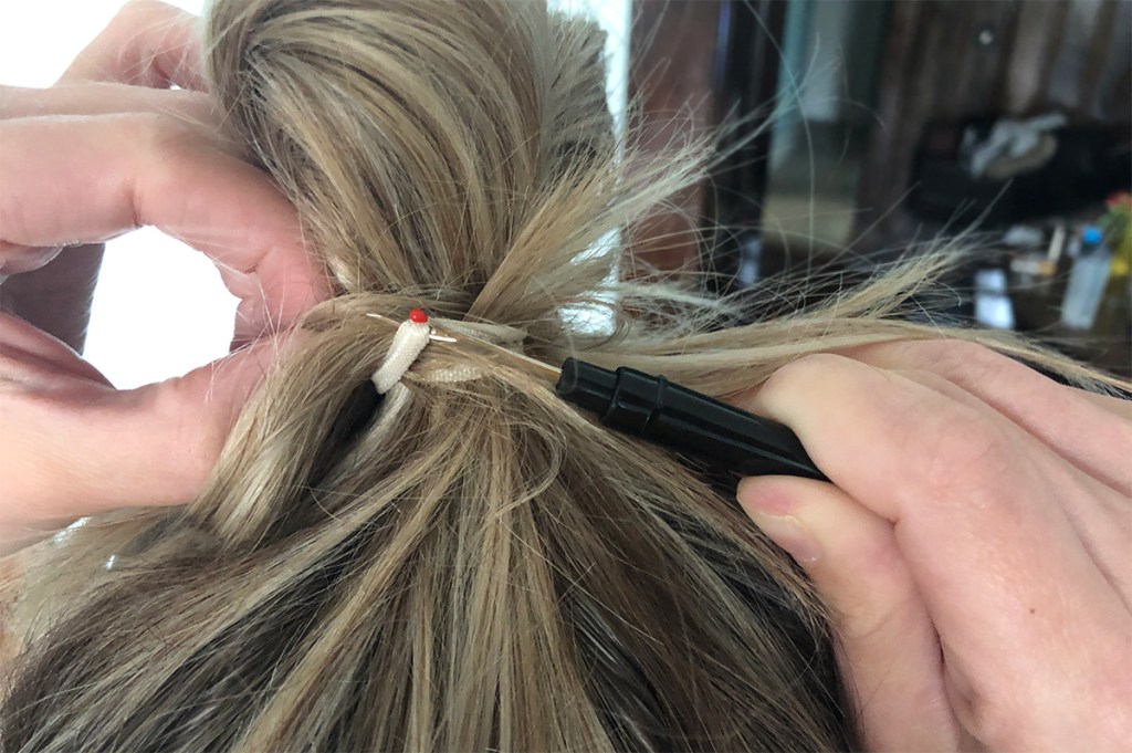 seam ripper cutting out tangled hair tie