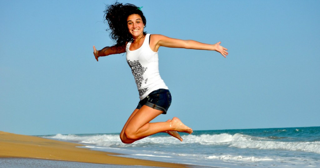 woman jumping at the beach