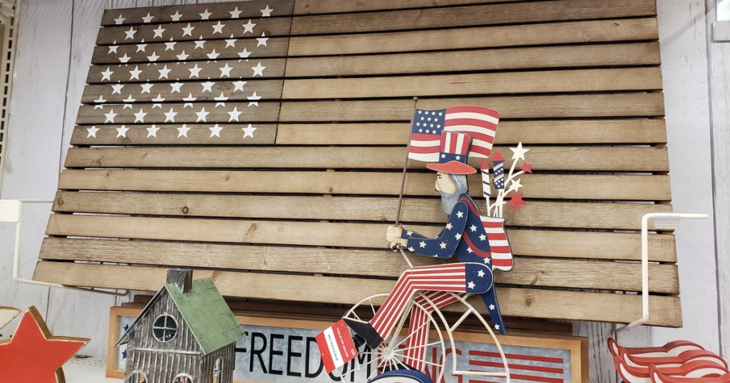 wooden american flag and wooden Uncle Sam riding a bike at Michaels