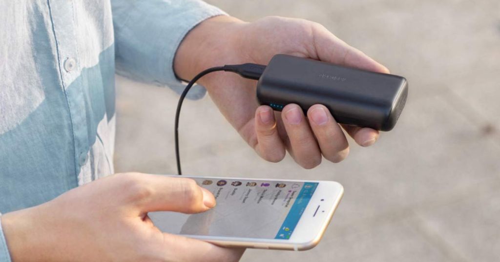 hand holding anker powercore charging iphone using snapchat