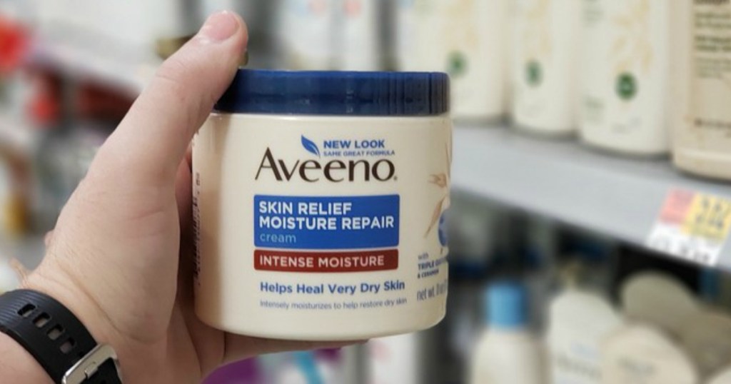 hand holding aveeno moisturizer