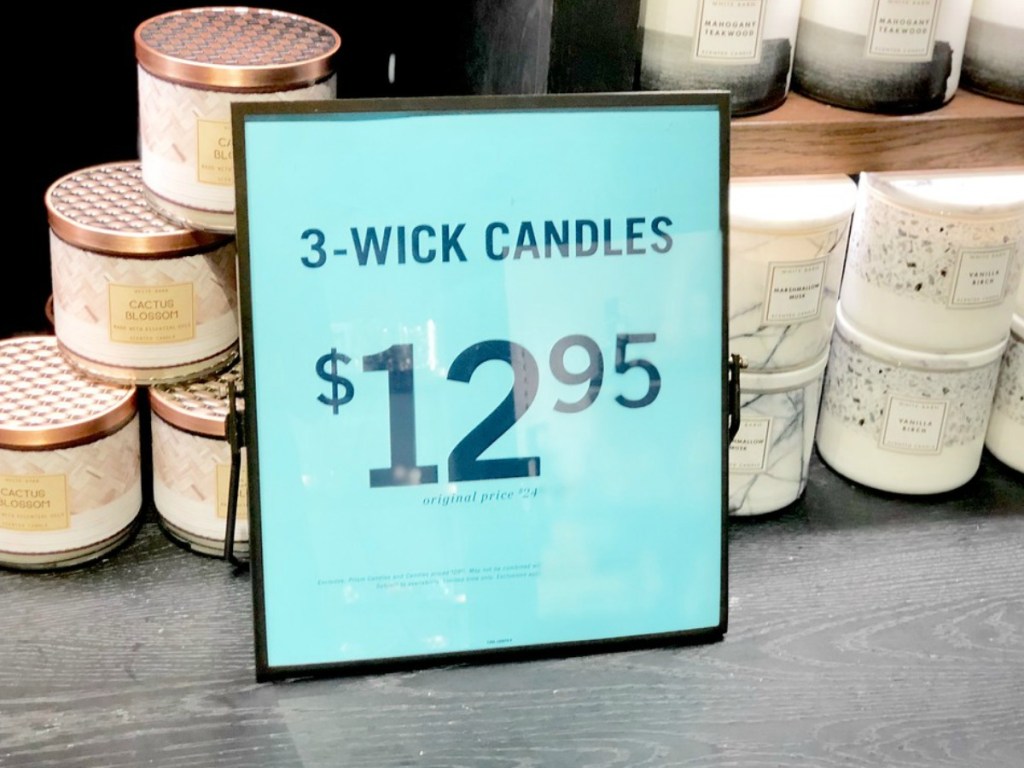 Bath & Body Works candles at the store with a sign that says $12.95