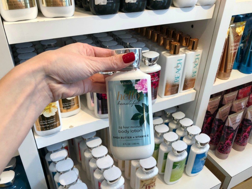 lady holding a Bath & Body Works lotion at the store