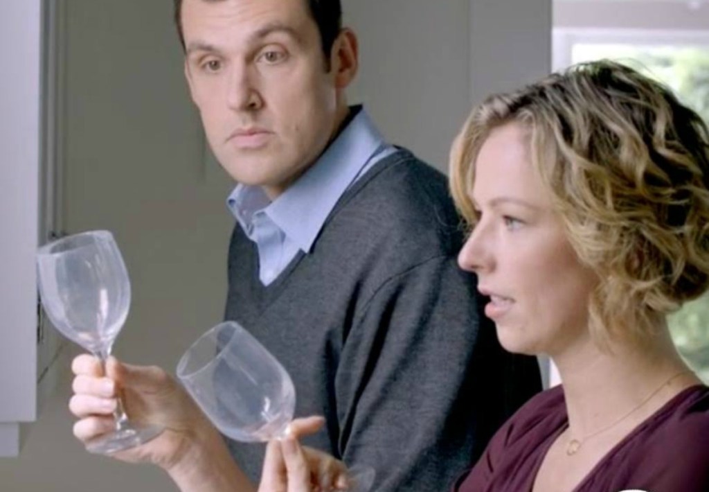 mand and woman looking at cloudy wine glasses