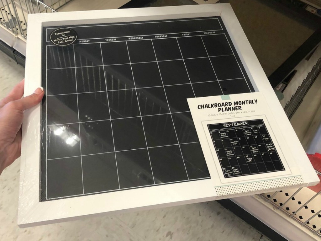 hand holding monthly chalkboard planner in store