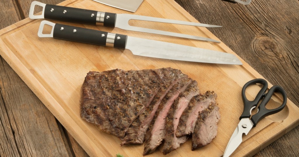 grilling tools next to cut up steak