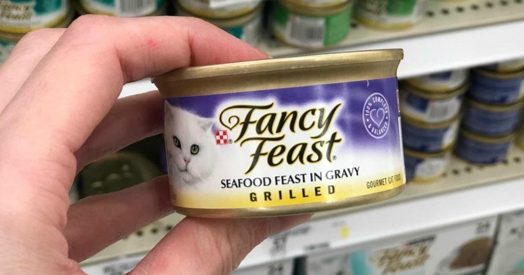 hand holding a can of Fancy Feast Seafood Feast in Gravy