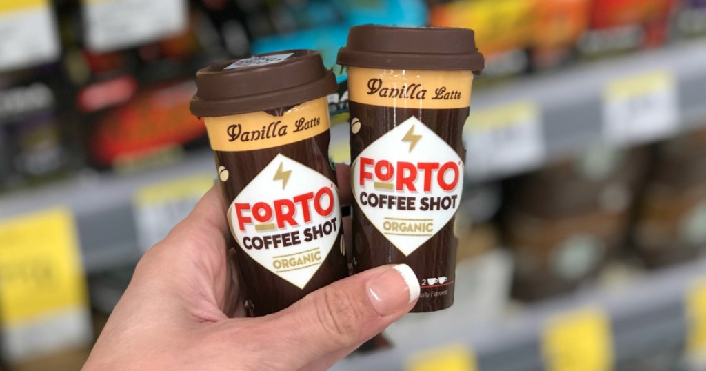 Manicured Hand holding two Forto packaged coffee sheets in vanilla latte flavor