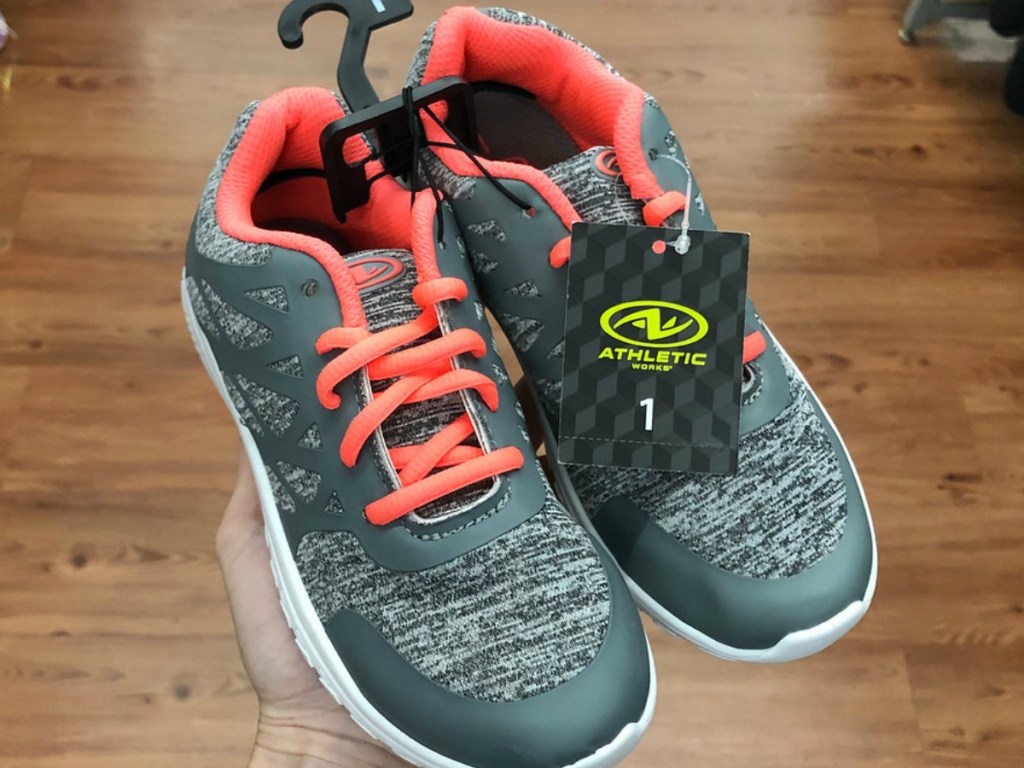 pair of girls shoes in grey with orange laces