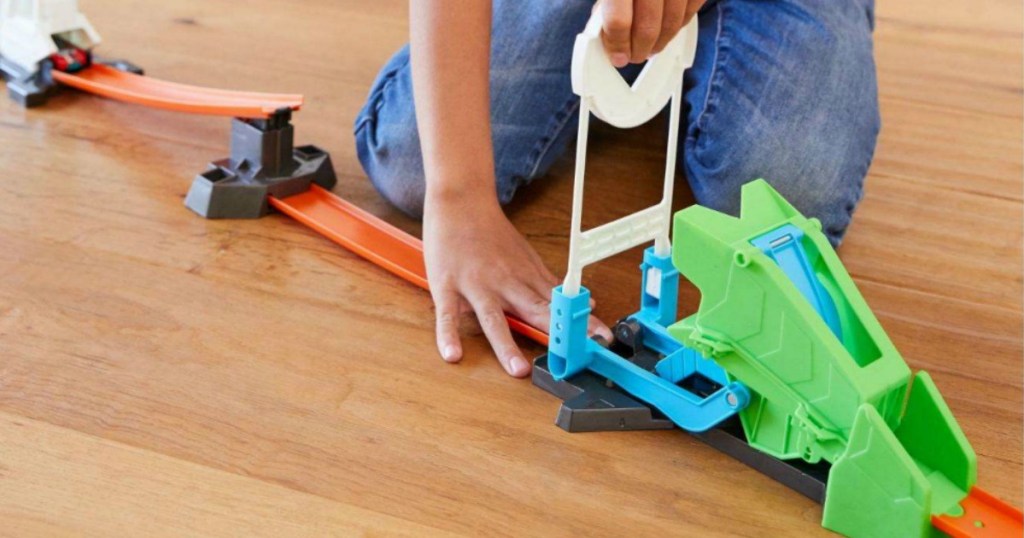 Kid building Hot Wheels Track Builder Set