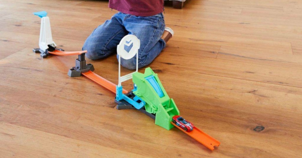 Kid playing with Hot Wheels Track Builder Set
