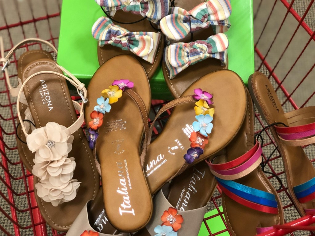 various pairs of sandals in a shopping cart at JCPenney