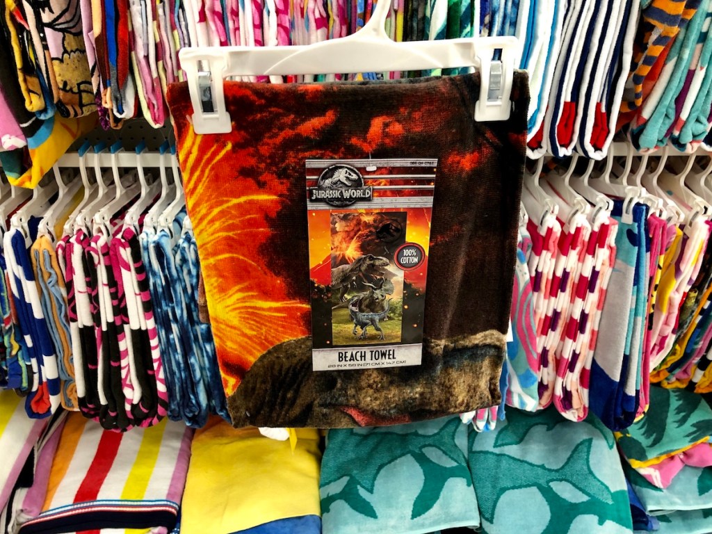 dinosaur beach towel in front of other towels