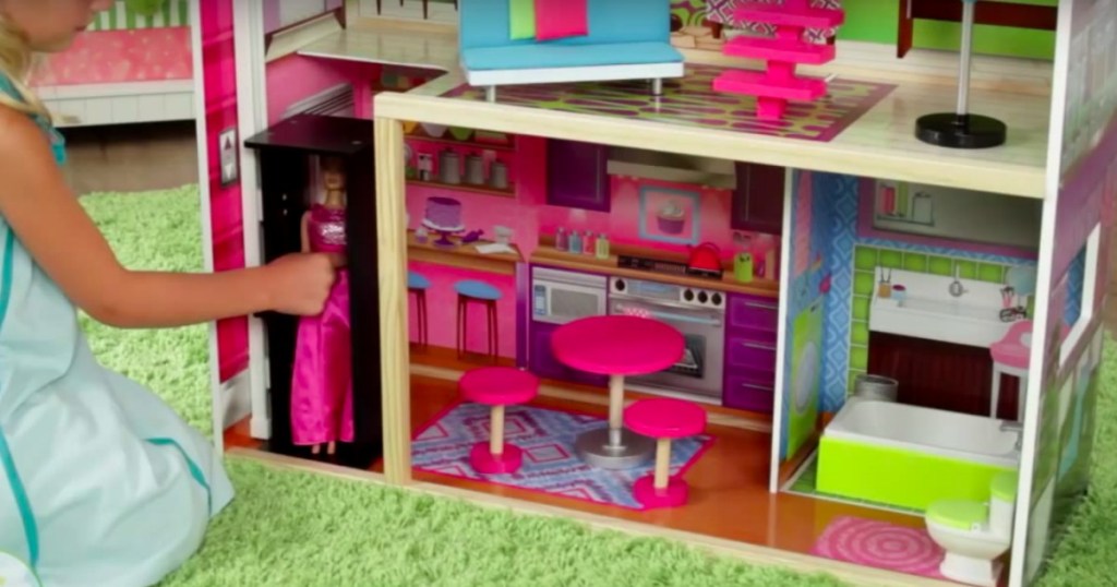 a doll in the elevator of the KidKraft Super Model Dollhouse