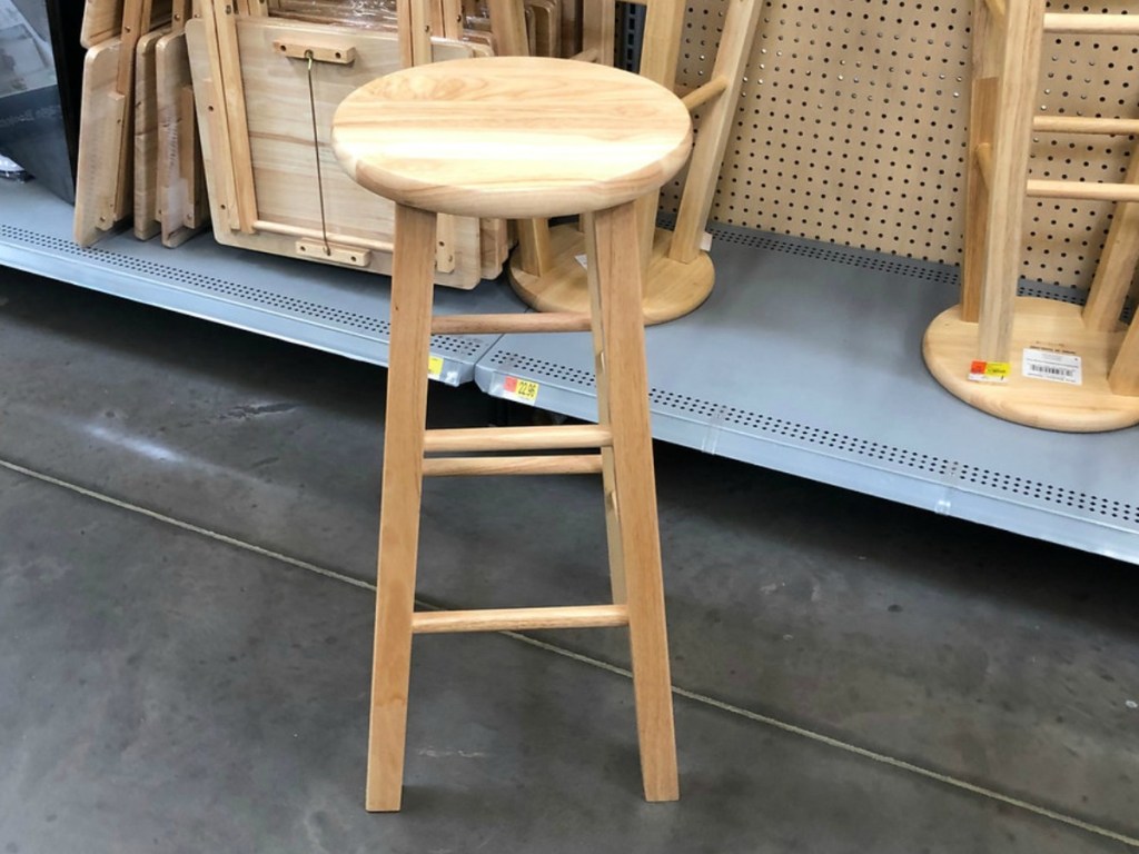 natural wooden stool near store display