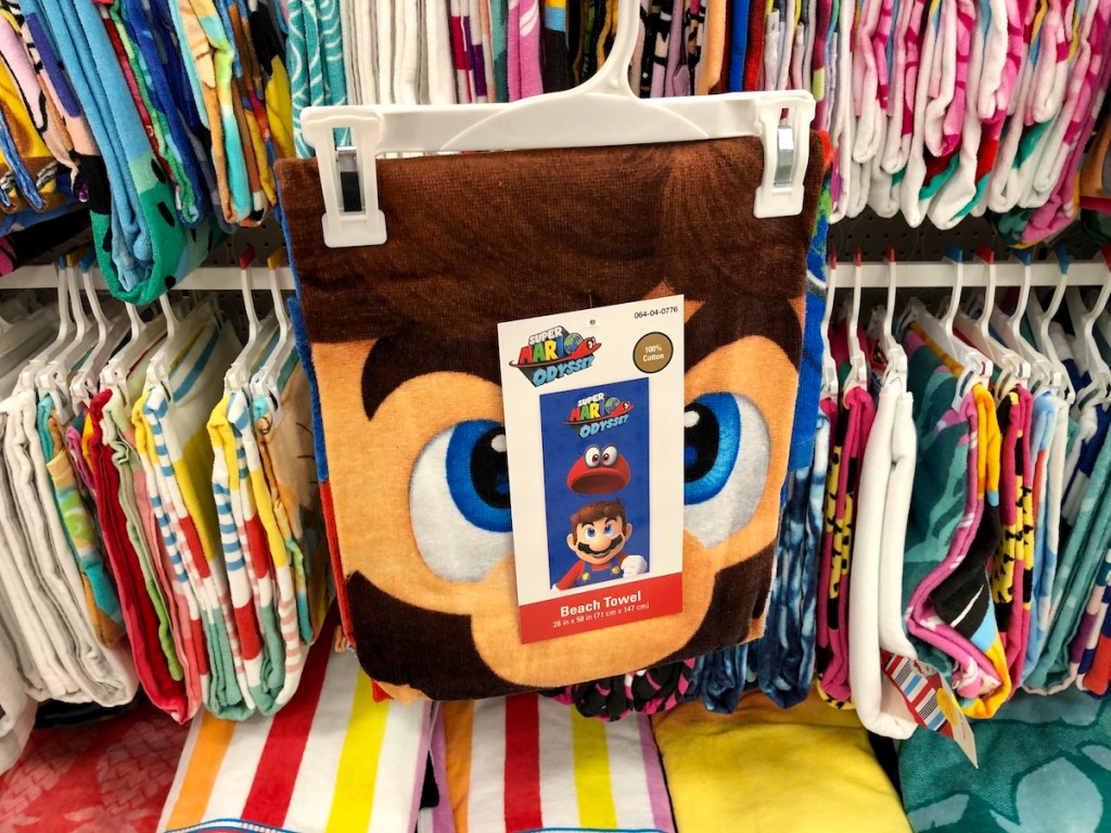 mario beach towel in front of other towels
