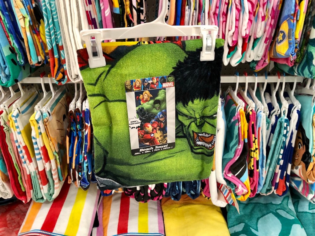 beach towel with hulk on it on a hanger in front of other towels