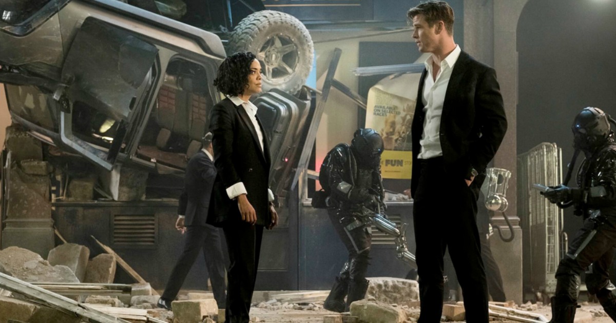 woman and man looking at each other in Men In Black International movie poster