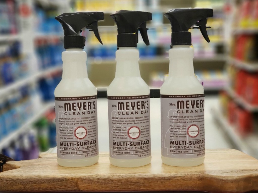 3 Mrs. Meyers Cleaning Spray bottles on wood table in store