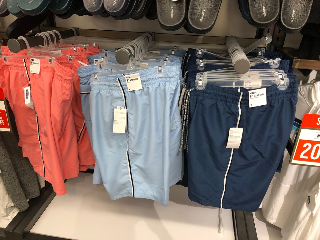 Old Navy Men's Swim Trunks hanging up in the store